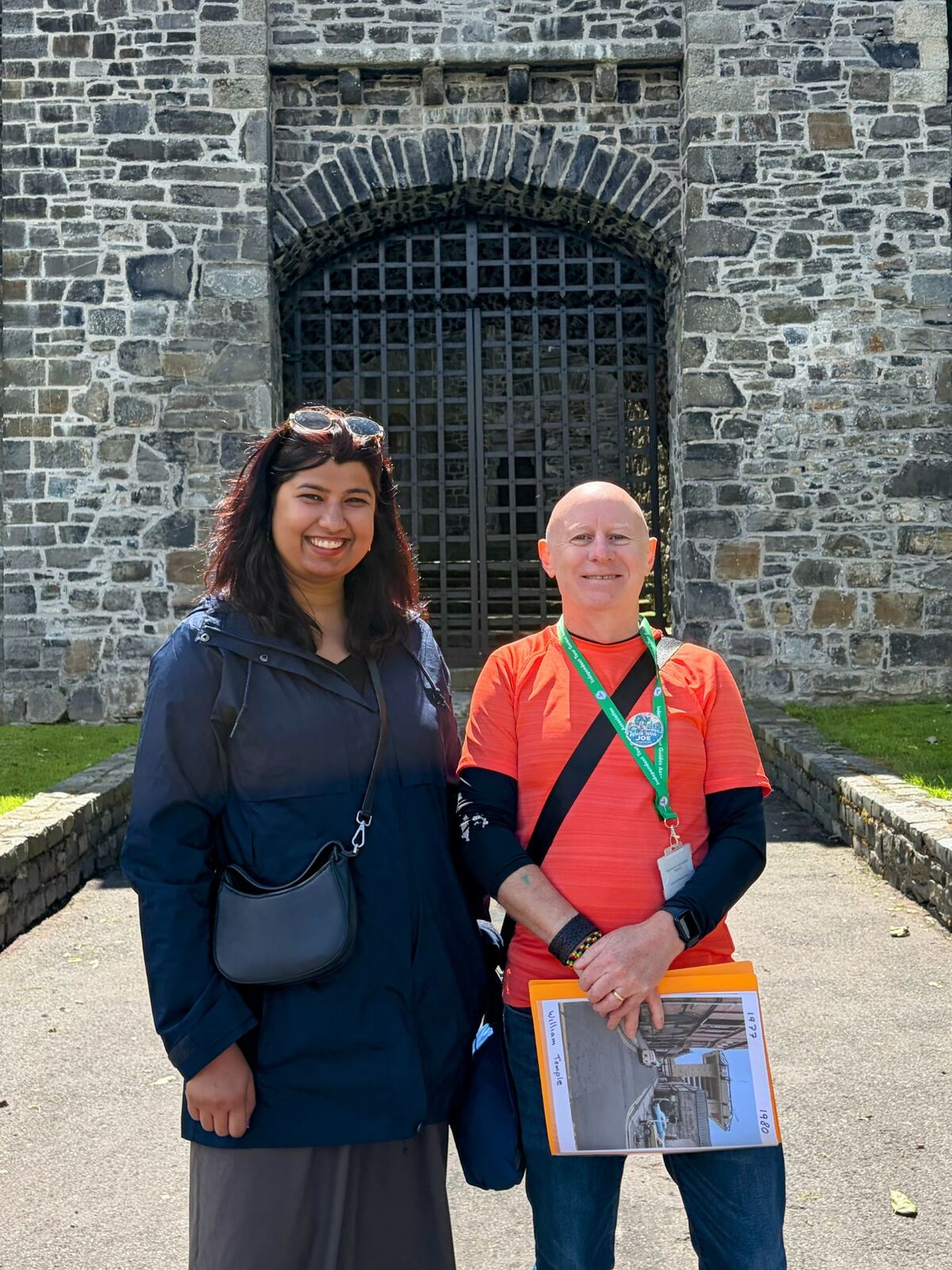 Joe with a guest at a medieval gateway