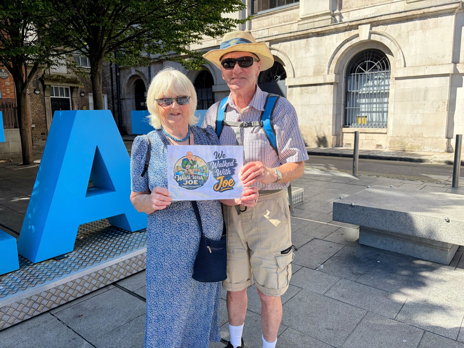 Guests holding the We Walked With Joe sign