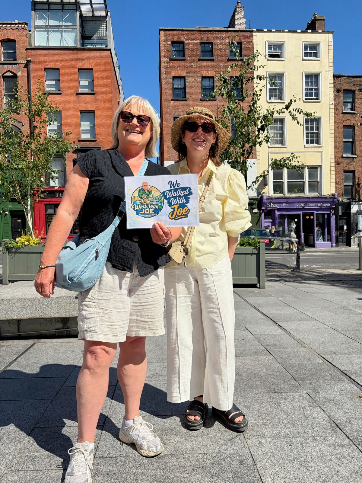 Two guests with the sign on a Dublin street