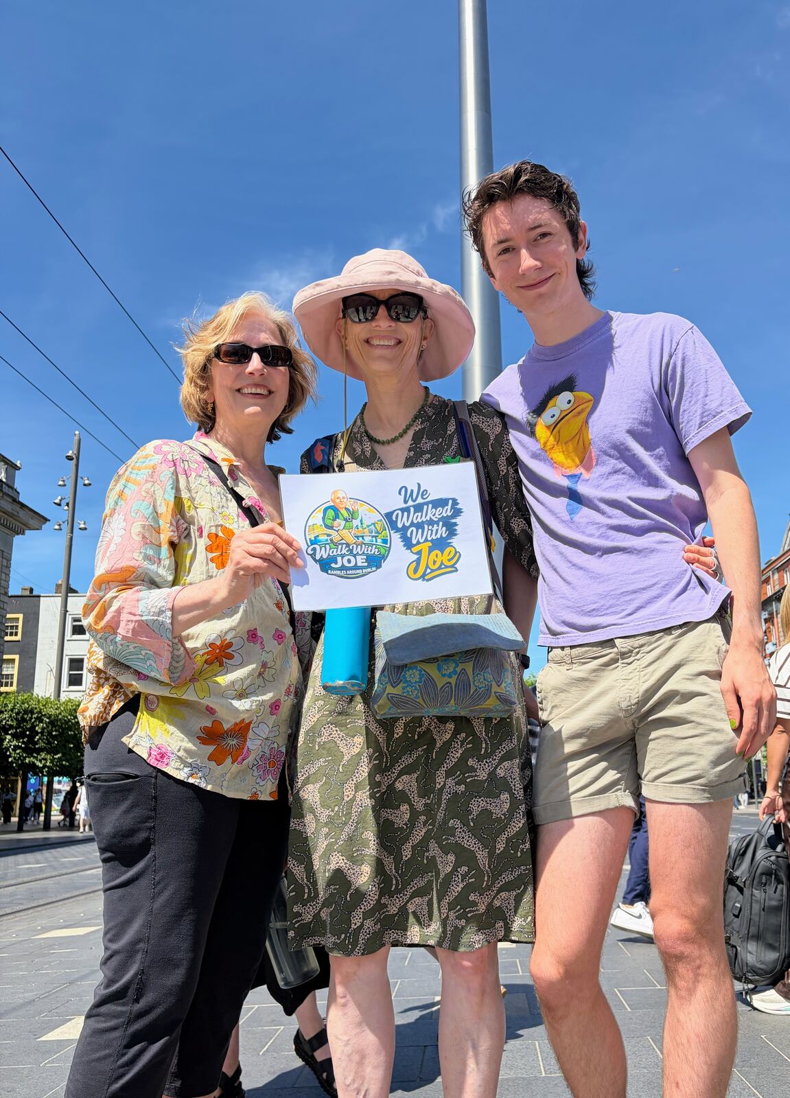 Three guests with the sign