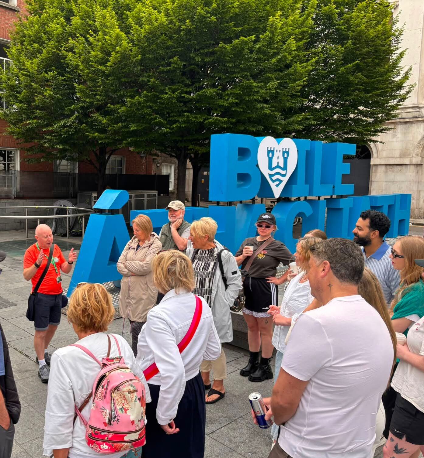 A crowd at the Baile Átha Cliath sign